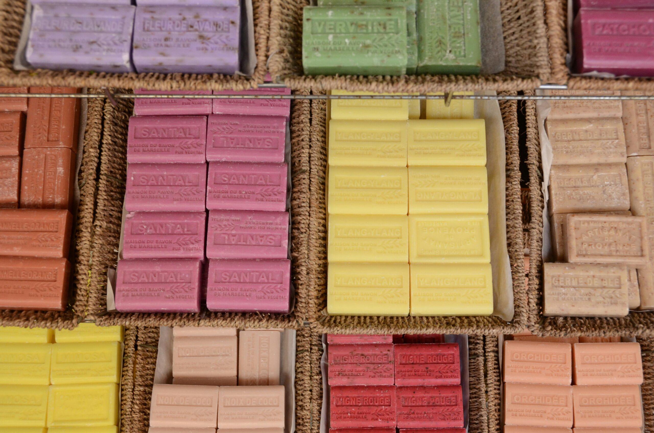 An open gift box filled with assorted organic flowers and small sustainable products