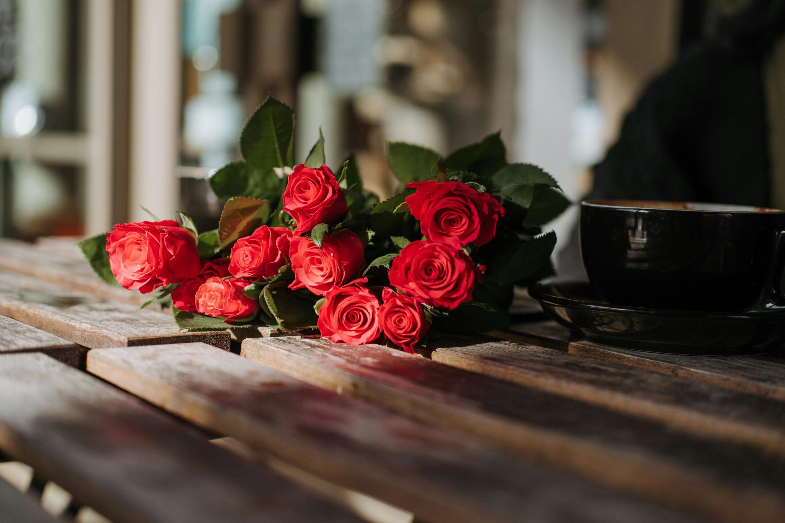 A colorful bouquet of organic roses, chamomile, and lavender sitting on a wooden table