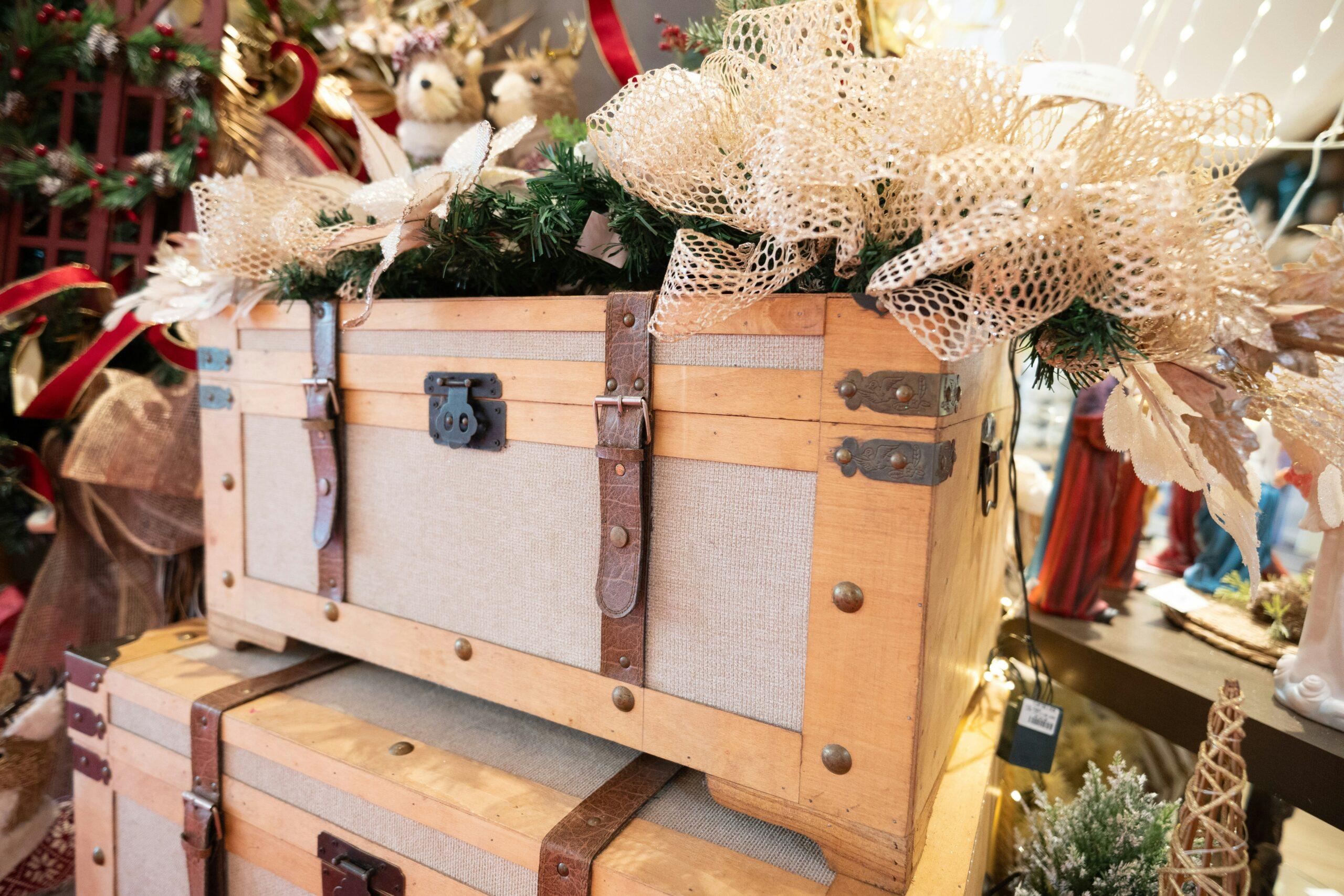 A rustic wooden box containing dried petals, scented oils, and string lights.