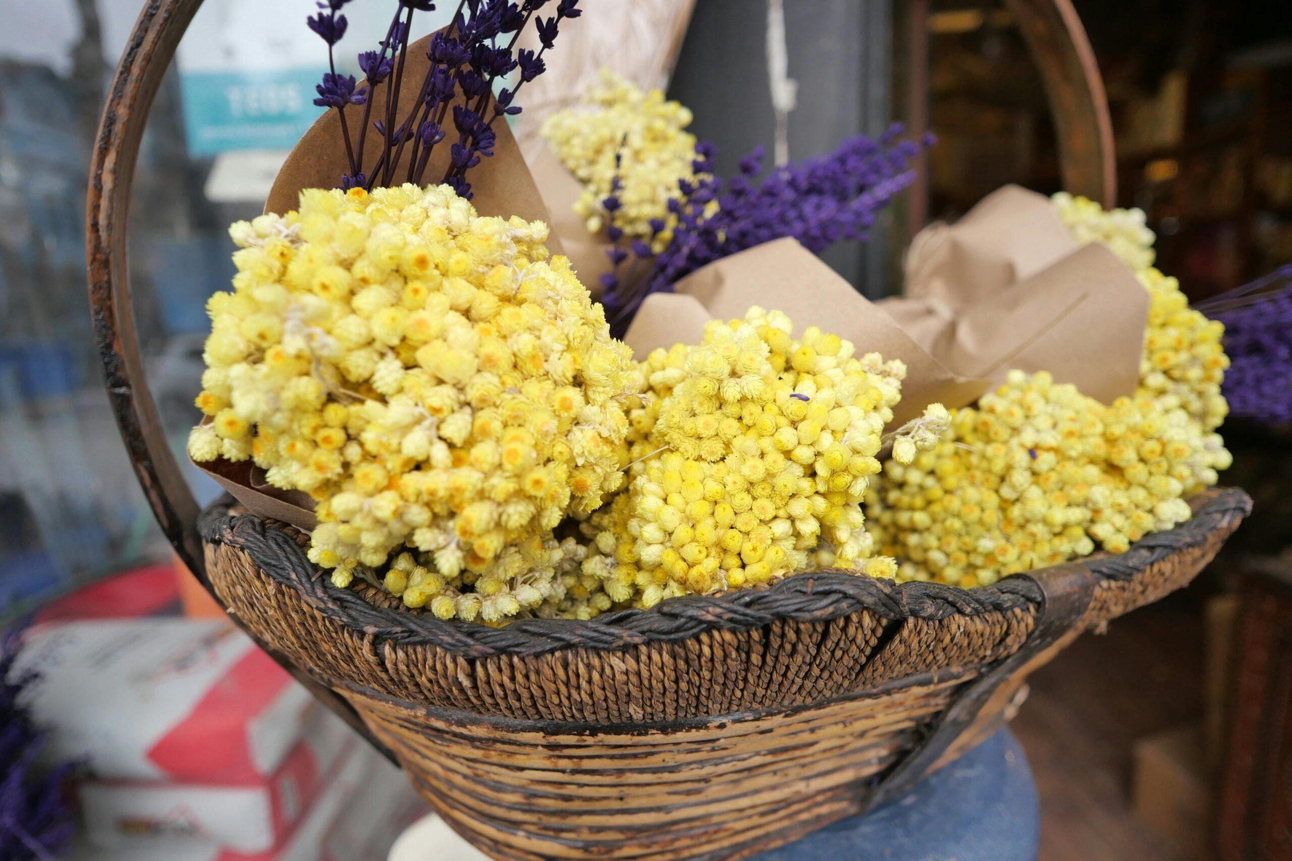 A wicker basket filled with organic herbs and flowers perfect for gifting