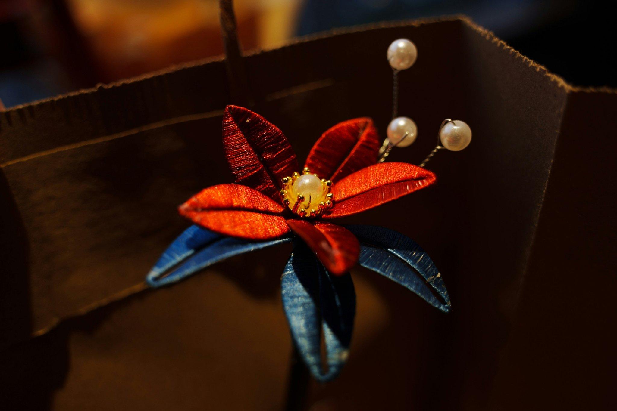 A basket of wilting roses on a wooden table